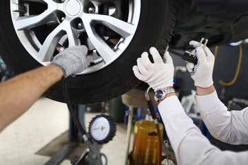 Mechanic repairing wheels, seasonal tire change