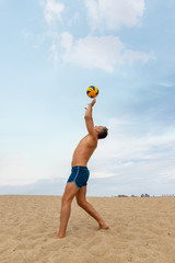 boy playing volleyball on the beach