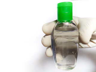 Hand sanitizer Bottle in hand wearing gloves Isolated on White background
