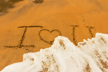 Words "I love you" in the sand