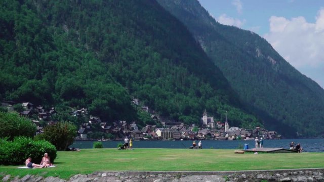 group of people walking on a mountain lake hallstatt 