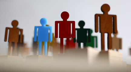 Plastic or wooden colored figures people team