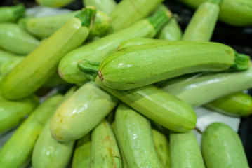 fresh zucchini standing at the market counter
