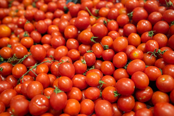 delicious and red tomatoes standing on market counter