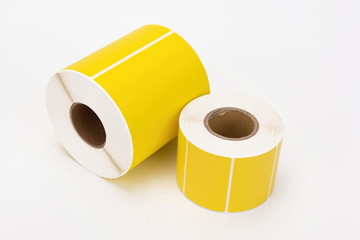 A roll of yellow thermal label printing paper