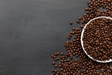 coffee bean on black wooden floor background. top view. space for text