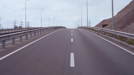 Traffic on a winding expressway. City traffic. Empty track.