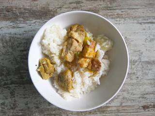 plate with rice and meat in an exotic sauce, top view
