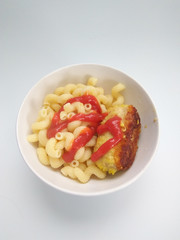 plate with delicious macaroni in chili sauce and meat, top view