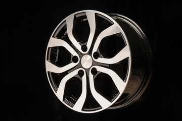 Obraz premium New car alloy wheel, close-up on a black background