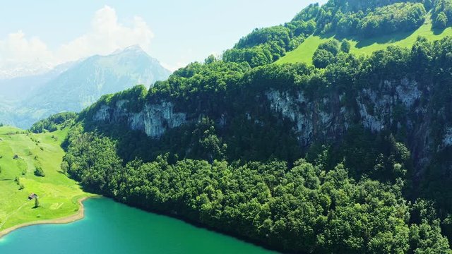 The Seelisberg is a lake below the village  in the canton Uri, Switzerland. The lake is about 18 ha, 700 to 800 m long, 350 m wide and 37 m deep. Cinematic drone video.