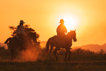 cowboy riding with horse in the sunset time