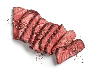 Poster Grilled sliced beef tenderloin steak with pepper isolated on white background top view © Karlis