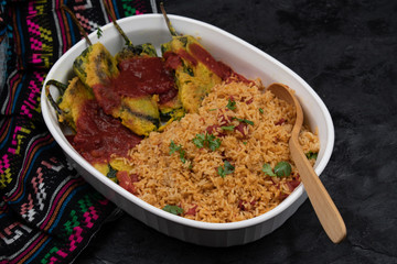 Vegetarian chiles rellenos cooked in eggless batter served with Mexican rice