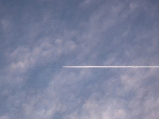 Trace of an airplane against blue sky