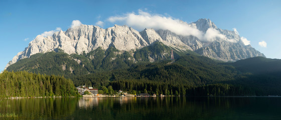 View of Zugspitze Mountains seen from bank of Lake Eibsee