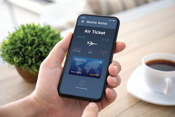 male hands holds phone with airplane ticket application airlines screen