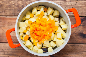 Step-by-step preparation of vegetable stew with potatoes and eggplant, step 4 - chopped bell pepper, top view, selective focus