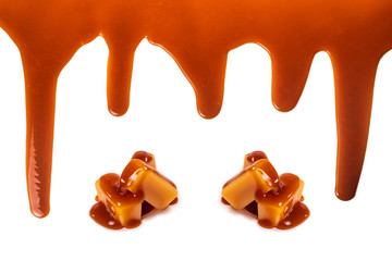 Background of flowing caramel sauce isolated on white.
