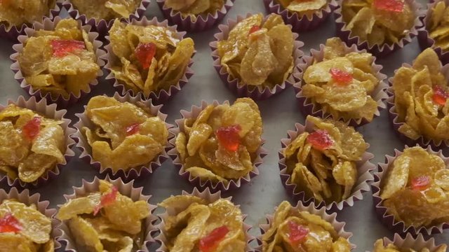 Handheld panning shot of honey cornflakes in baking tray during Eid Mubarak.