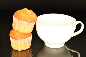 Fresh tasty muffins, close-up, on a black background.