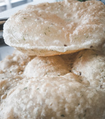 Indian wheat puris stacked on each other . Good healthy indian breakfast
