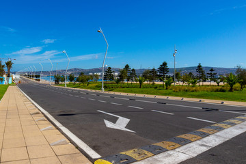 Empty road and Tanja Marina Bay in Tangier, Morocco