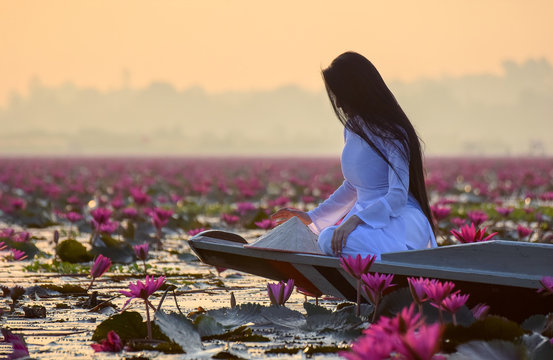 Asian Woman With White Dress Sit On Boat In Waterlilly Lake