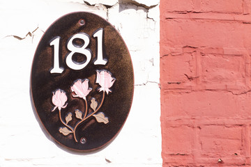 House number 181 with roses