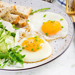 English breakfast - fried eggs, feta cheese, cucumber and arugula. American food.