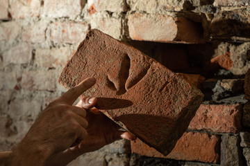  Man worker reconstructing old stone wall