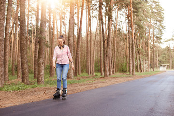 Portrait of adorable sweet pretty young woman wearing striped sweatshirt and jeans, having...