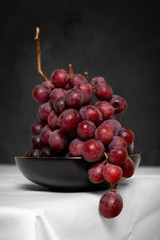 Fresh grape on grey concrete background.