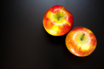 Apples on black table, food background