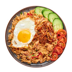 Nasi Goreng - Indonesian Chicken Fried Rice on black plate isolated on white backdrop. Nasi Goreng...