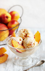 homemade creamy ice cream with peach in a glass bowl