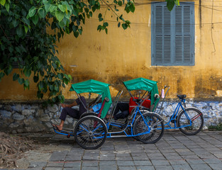 Fototapeta na wymiar vietnamese man taking a nap on the street during work