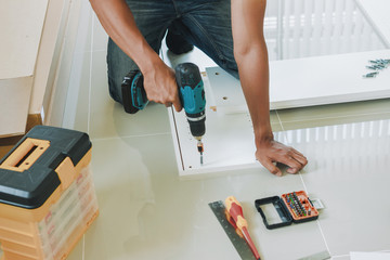 Service man assembling furniture for customer, Delivery service furniture store and assembling for buyer.