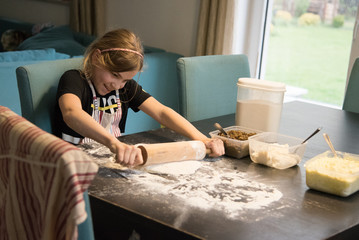Young girl making a dough