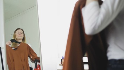 The woman does not know what to wear today