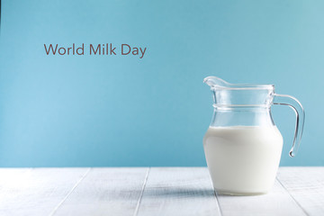  Banner. Jug of milk on a blue background. Lettering Milk Day. June 1st Copy space.