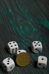Dice in white with black dots and a coin. On brushed pine boards.