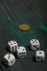 Dice in white with black dots and a coin. On brushed pine boards.