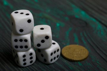 Dice in white with black dots and a coin. On brushed pine boards.