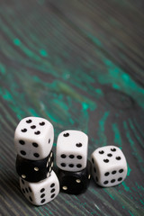 Dices are white and black. On brushed pine boards.