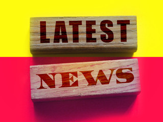 Latest News words on a wooden blocks on yellow and magenta background. Fake or real facts concept....