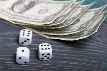 Dice are white. Near dollars. On brushed pine boards.