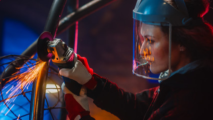 Portrait of Talented Innovative Tomboy Female Artist Using an Angle Grinder to Make Abstract,...