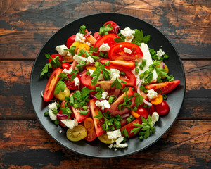Tomato salad with feta cheese, spring onion and parsley. Healthy summer food