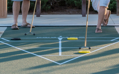 A game of shuffleboard in progress, an outdoor activity especially popular in senior communities